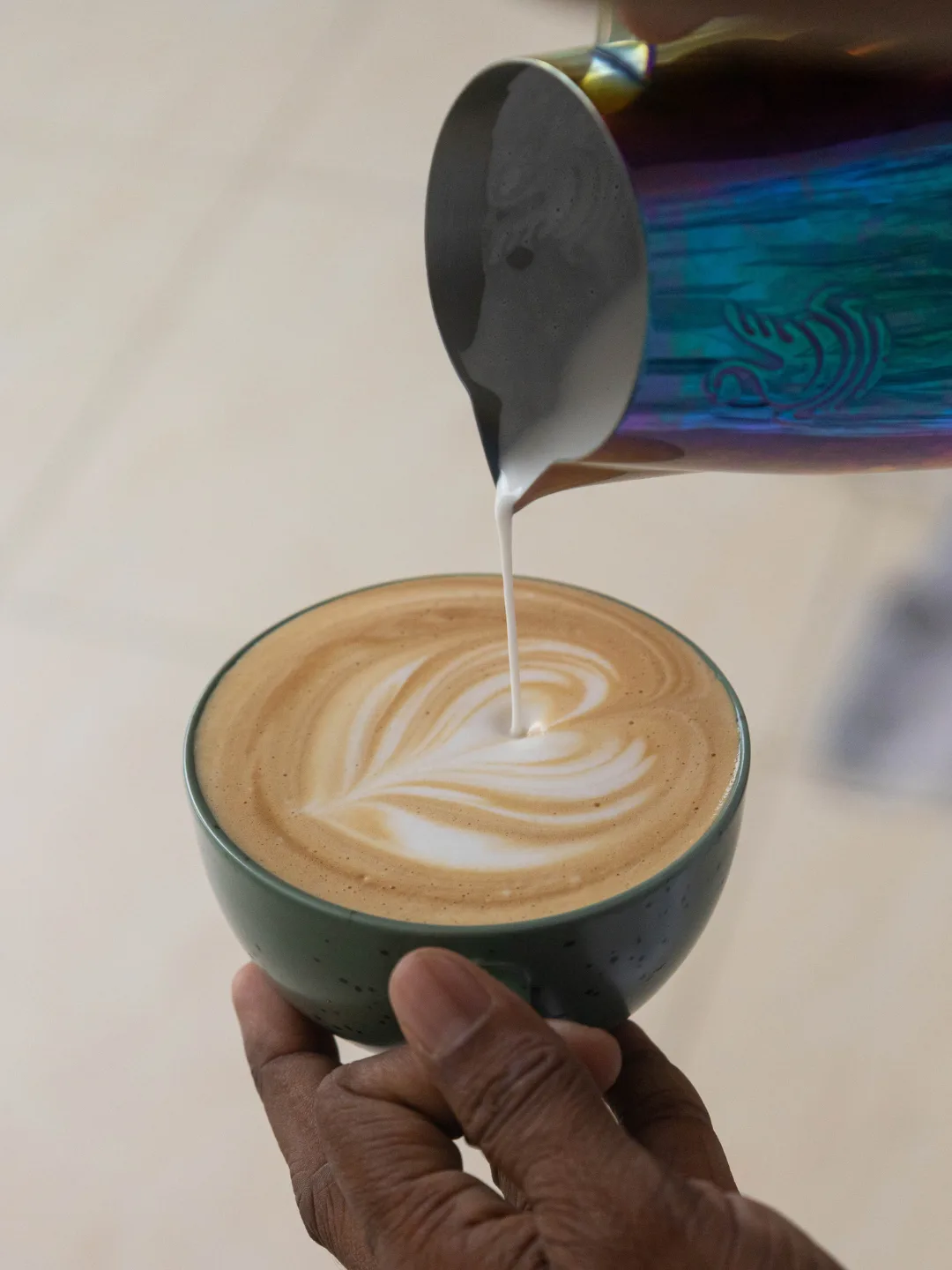 Latte art being poured at Mira Cafe in Mirissa, Sri Lanka