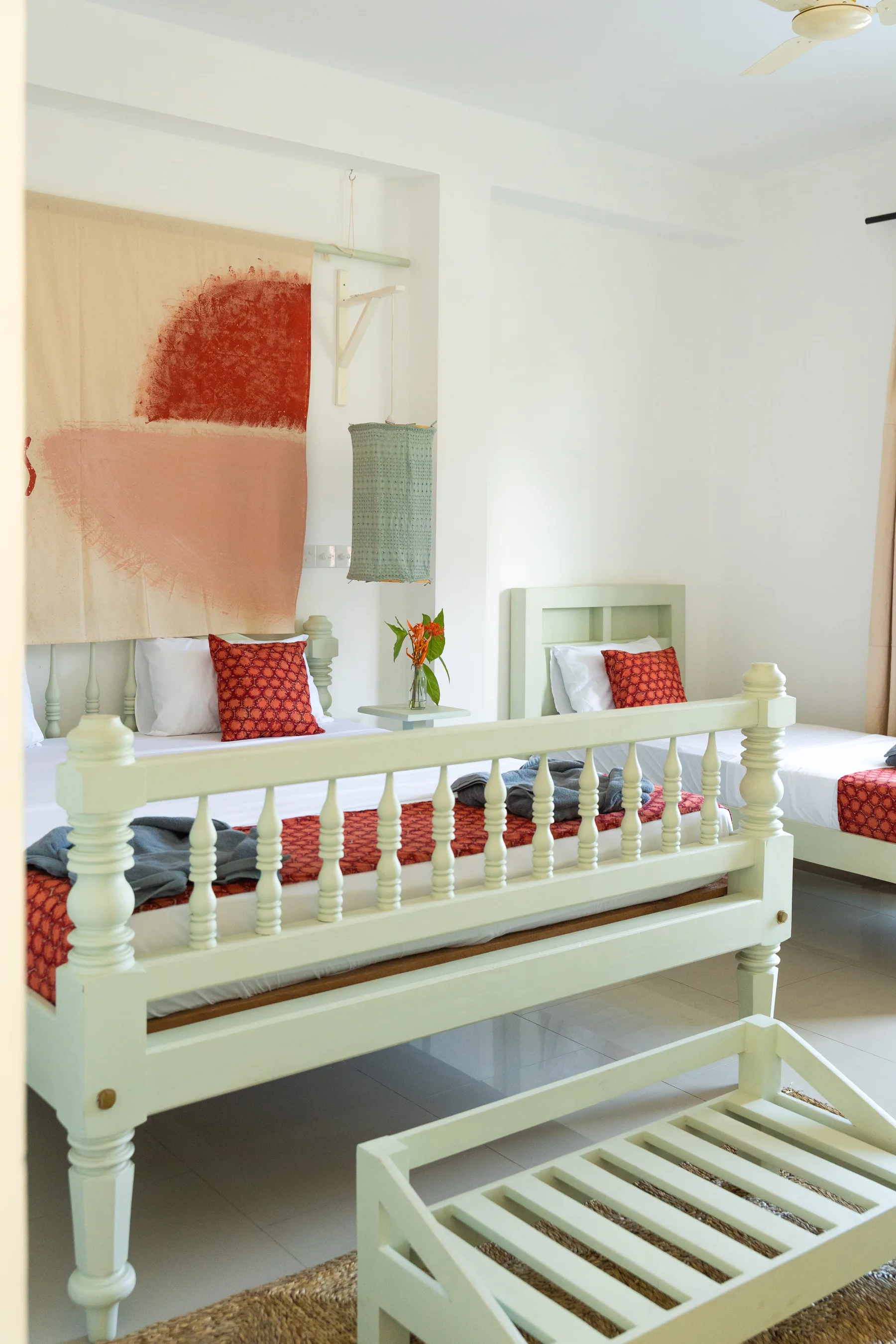 Double bed and bench in a private room at MiRA Mirissa